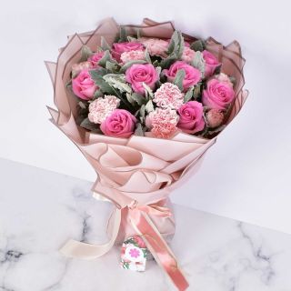 Pink and cream rose bouquet wrapped in blush pink paper – All About Roses collection